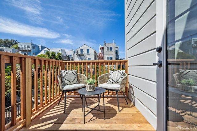 a bedroom with a large bed and wooden floor