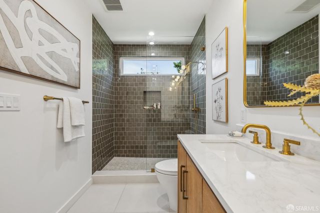 a bathroom with a sink mirror and toilet