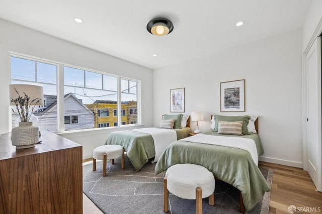 a bedroom with two beds and a chandelier