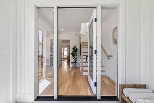 a view of a living room and entryway with wooden floor