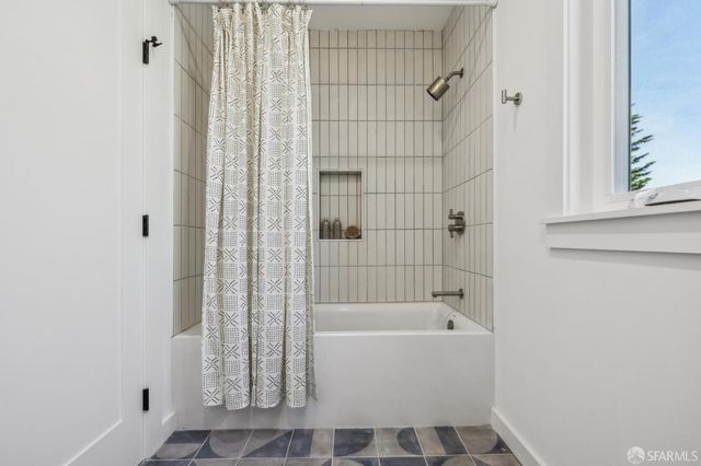 a bedroom with bed and a potted plant