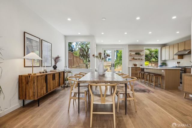 a view of a dining room with furniture window and wooden floor