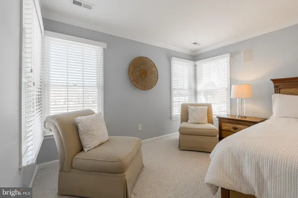 a bedroom with furniture and a large window