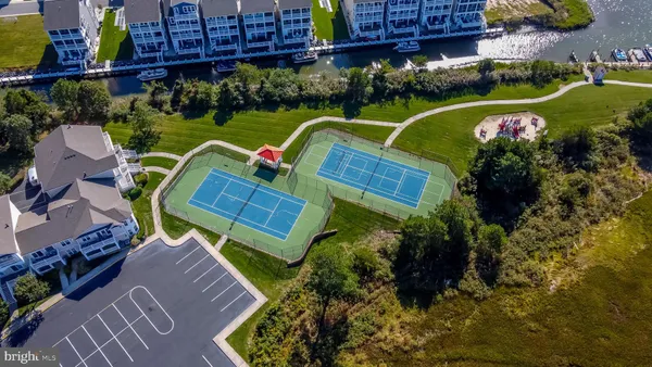 an aerial view of a house with a garden and lake view