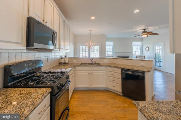 a kitchen with a stove a sink and a microwave