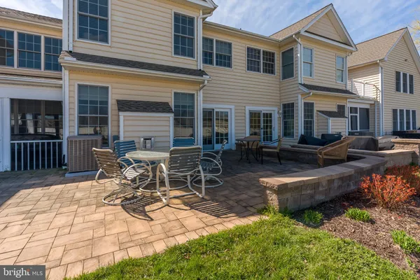a view of a patio with table and chairs and wooden fence
