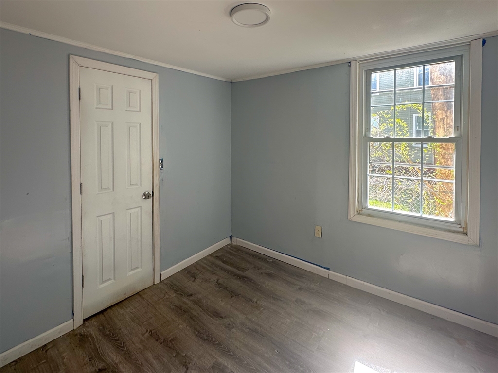 120 Hampden Street West Springfield, MA 01089 - Photo 7 of 19 an empty room with wooden floor and windows