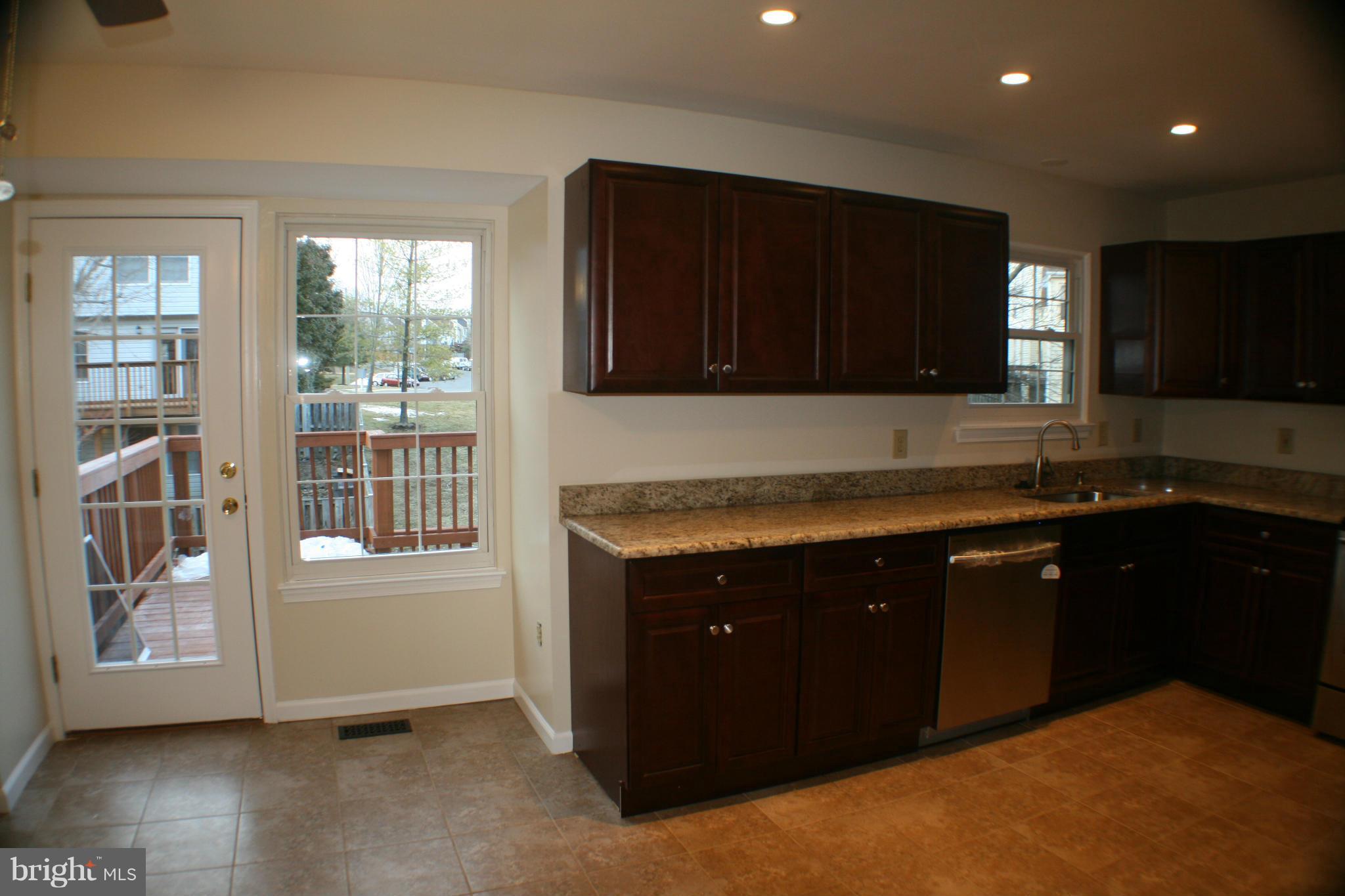 13930 Baton Rouge Court Centreville, VA 20121 - Photo 17 of 26 a kitchen with granite countertop a stove and a refrigerator