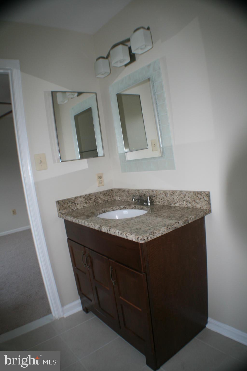13930 Baton Rouge Court Centreville, VA 20121 - Photo 5 of 26 a view of kitchen island with granite countertop sink