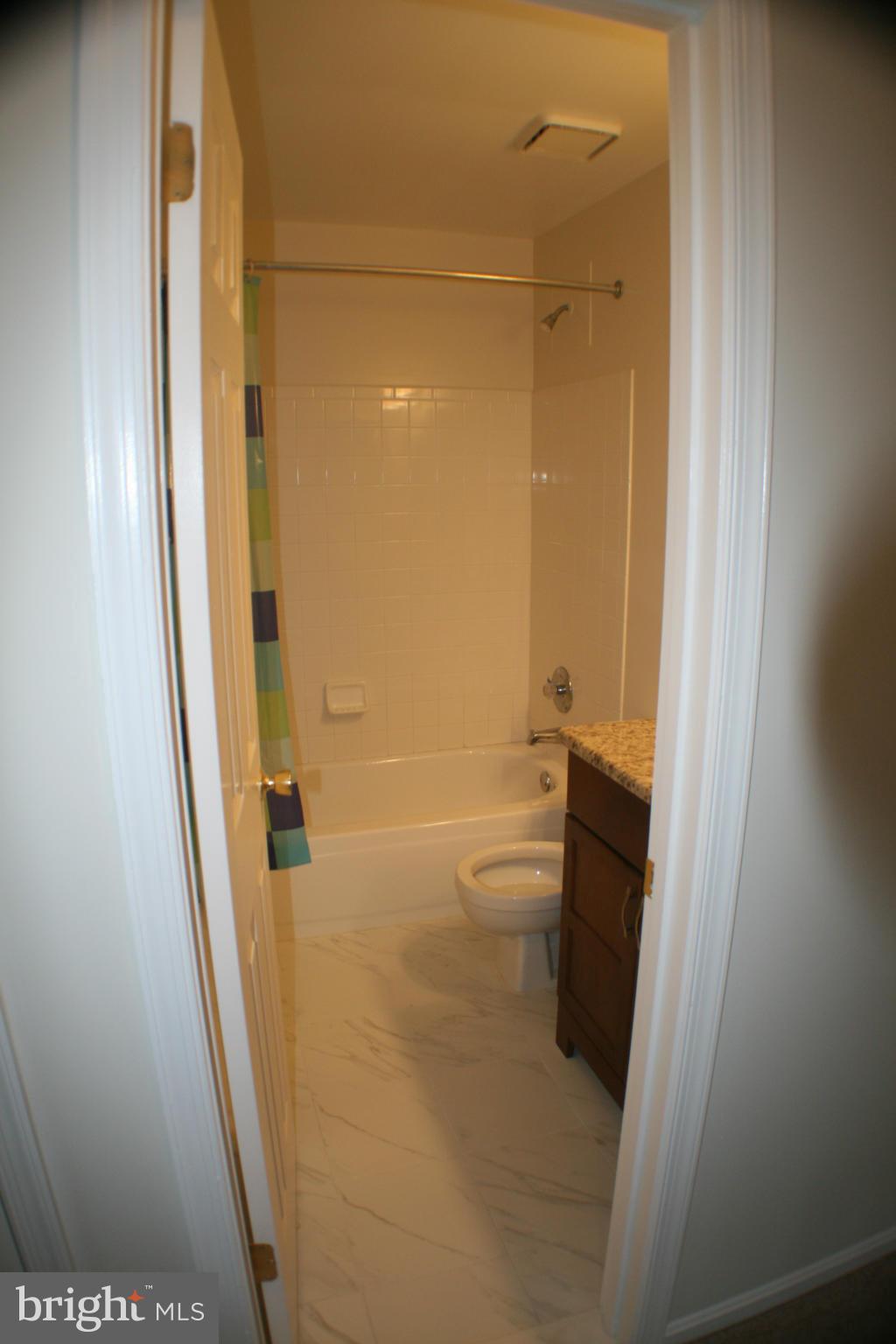 13930 Baton Rouge Court Centreville, VA 20121 - Photo 10 of 26 a bathroom with a granite countertop shower and a sink