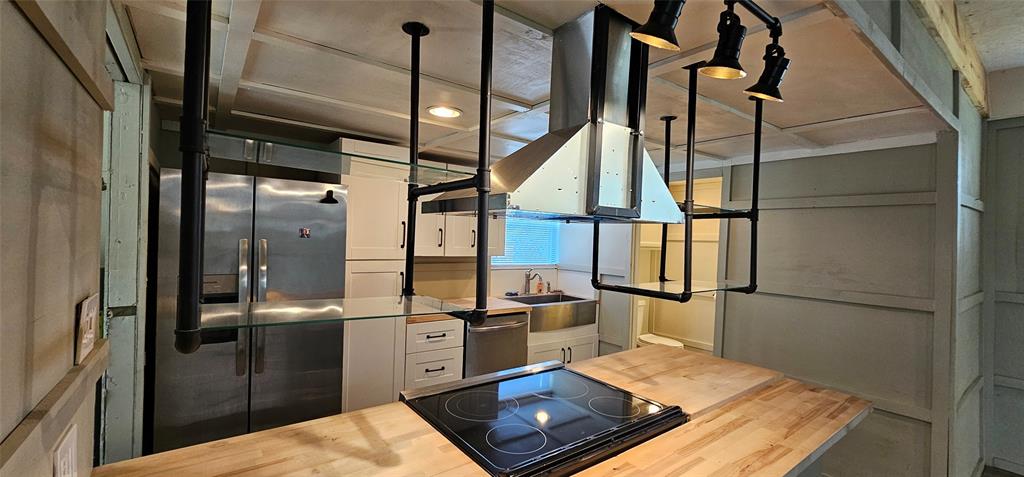 444 Geronimo Quitman, TX 75783 - Photo 13 of 34 a kitchen with stainless steel appliances granite countertop a refrigerator and a sink