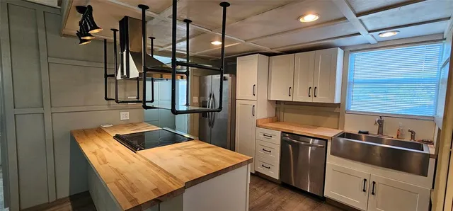a kitchen with cabinets and stainless steel appliances
