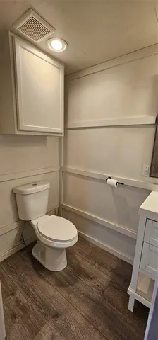 a bathroom with a toilet a sink and shower