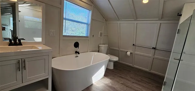 a spacious bathroom with a bathtub and sink