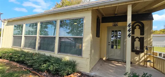 a front view of a house with a large window