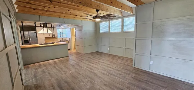 a view of a room with wooden floor