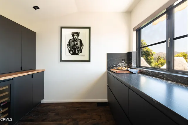 a front view of a house with a yard and potted plants
