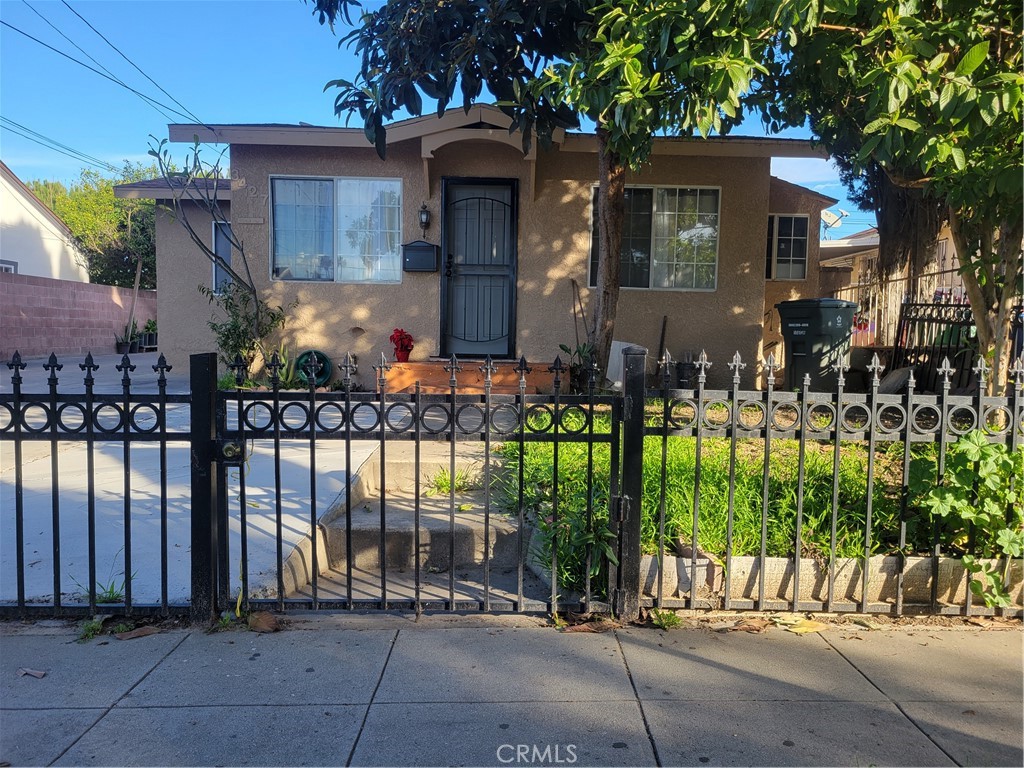3427 Bell Avenue Bell, CA 90201 - Photo 1 of 12 a front view of a house with a garden