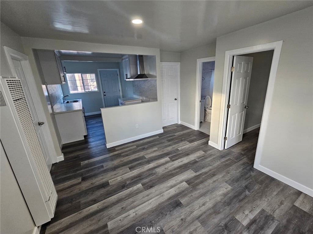 3427 Bell Avenue Bell, CA 90201 - Photo 4 of 12 wooden floor in an empty room with a mirror