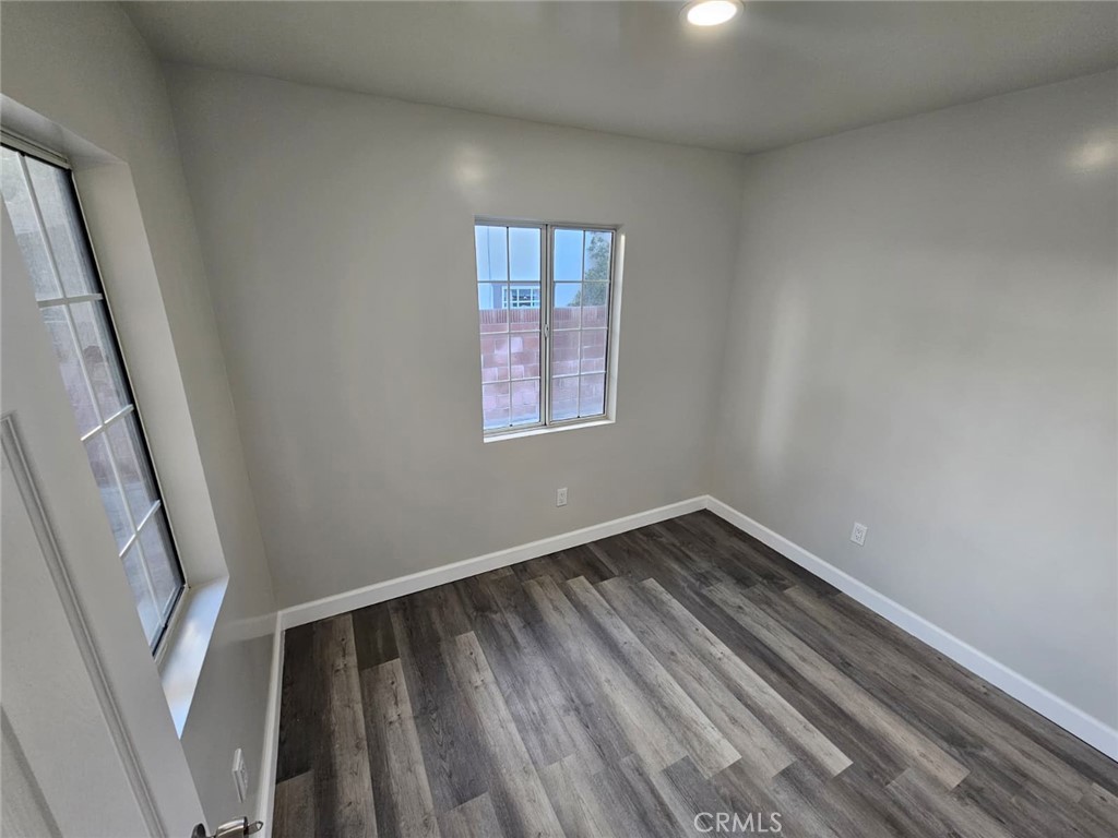 3427 Bell Avenue Bell, CA 90201 - Photo 8 of 12 a view of an empty room with wooden floor and a window