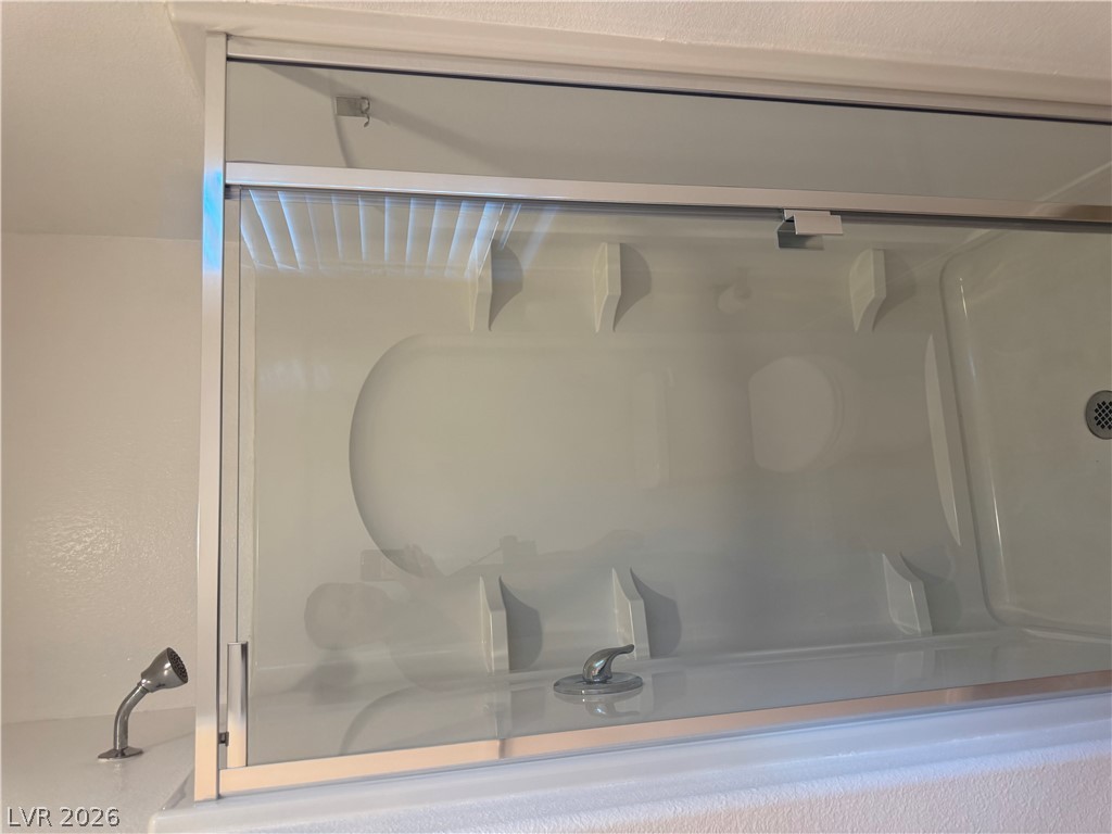 55 Canopus Ridge Way Las Vegas, NV 89183 - Photo 21 of 53 A glass-enclosed shower and tub combination offers clean architectural lines.