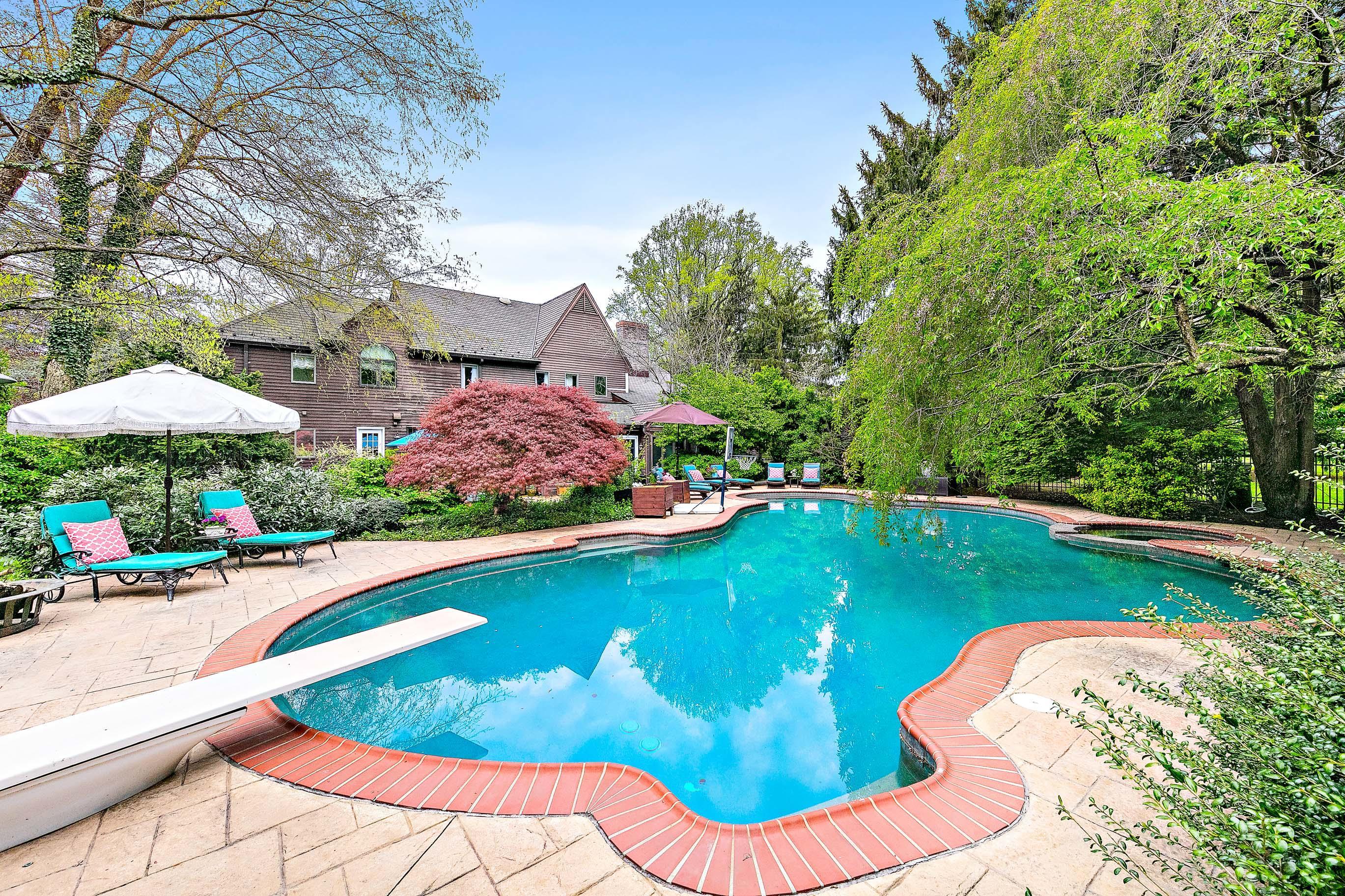 5 Post Road Rumson, NJ 07760 - Photo 52 of 67 a view of a swimming pool with an outdoor space and seating area