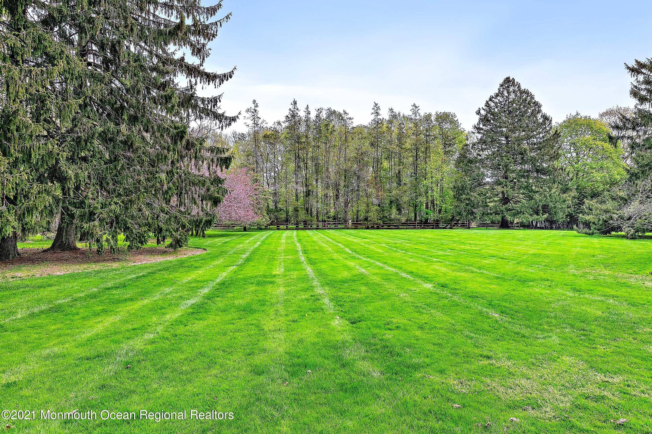 5 Post Road Rumson, NJ 07760 - Photo 57 of 67 a view of a grassy field with trees in the background