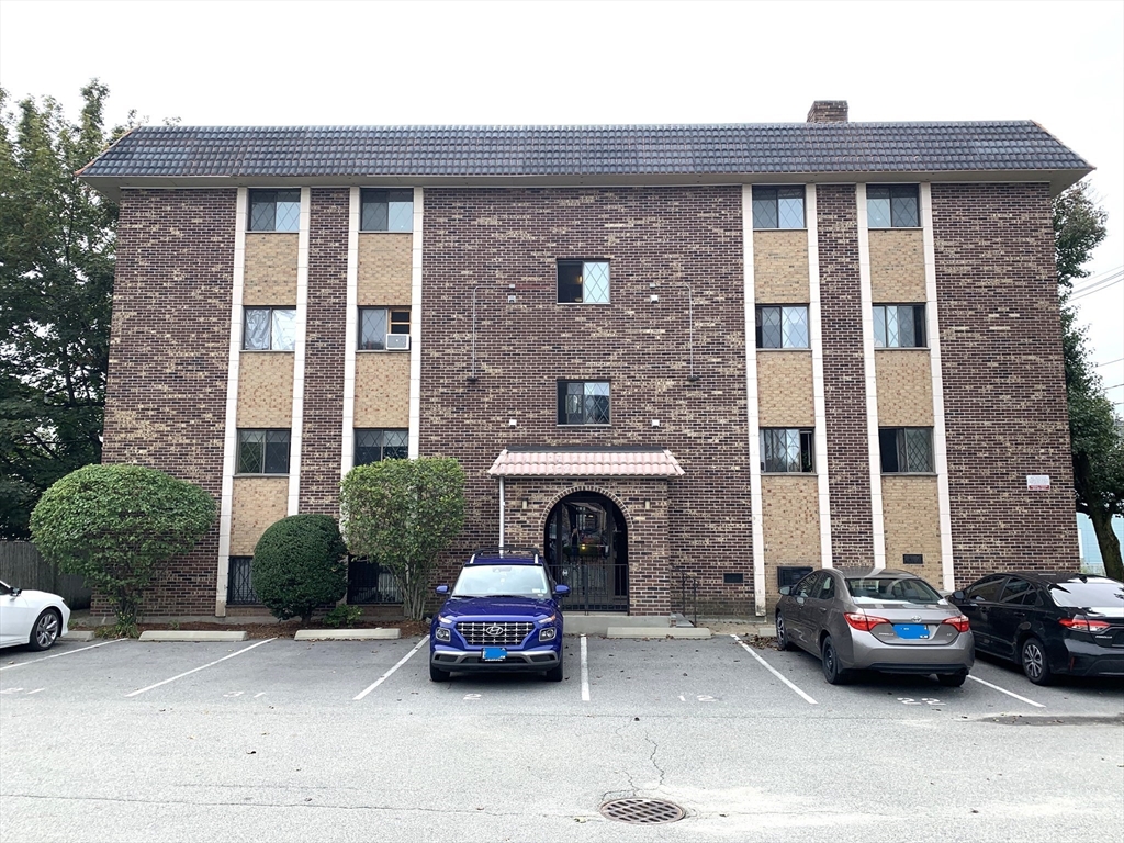 a car parked in front of a brick building