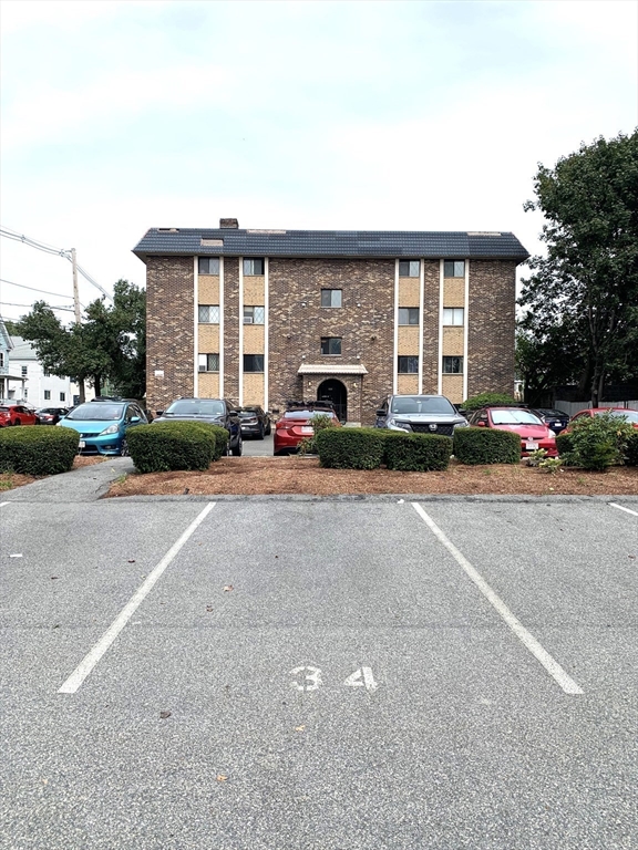 301 Lowell Street, Unit 34 Somerville, MA 02145 - Photo 15 of 15 a cars parked in front of a house