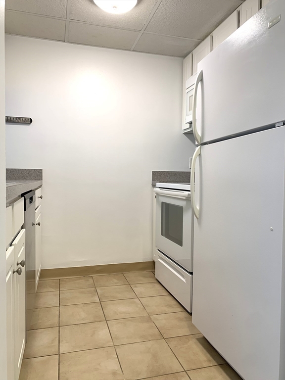 301 Lowell Street, Unit 34 Somerville, MA 02145 - Photo 4 of 15 a view of a storage and utility room with washer and dryer