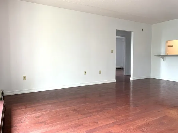 a view of a room with wooden floor