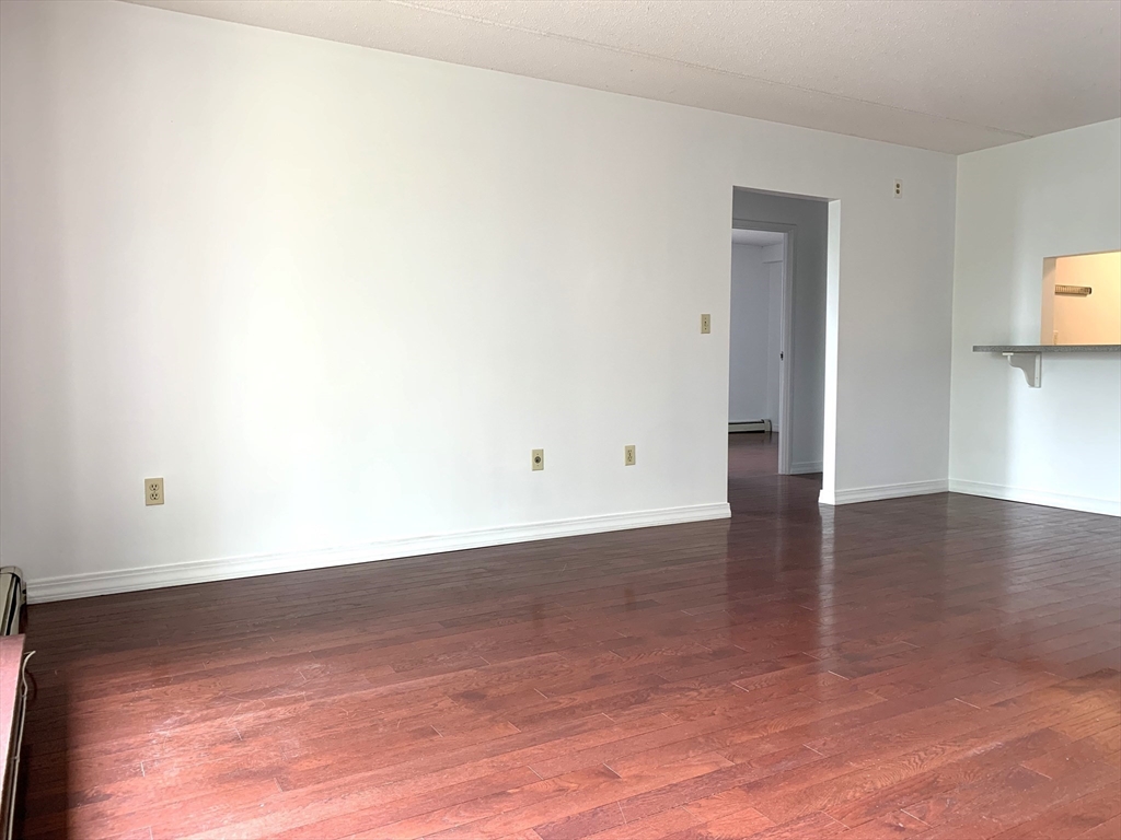 301 Lowell Street, Unit 34 Somerville, MA 02145 - Photo 7 of 15 a view of a room with wooden floor