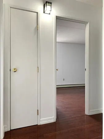 a view of a room with wooden floor