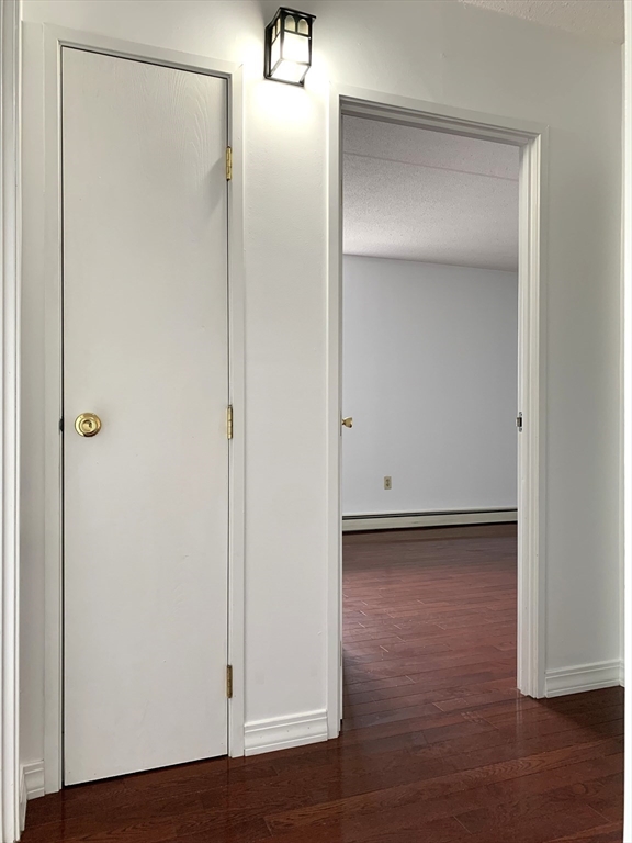 301 Lowell Street, Unit 34 Somerville, MA 02145 - Photo 8 of 15 a view of a room with wooden floor