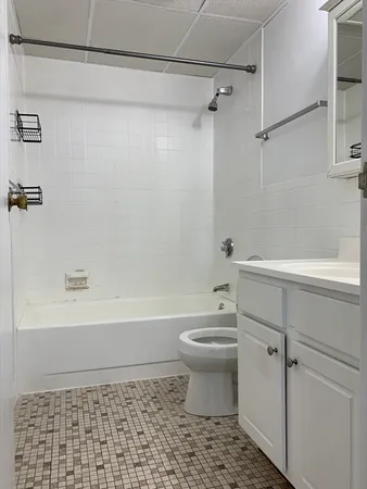a bathroom with a toilet a sink and bathtub