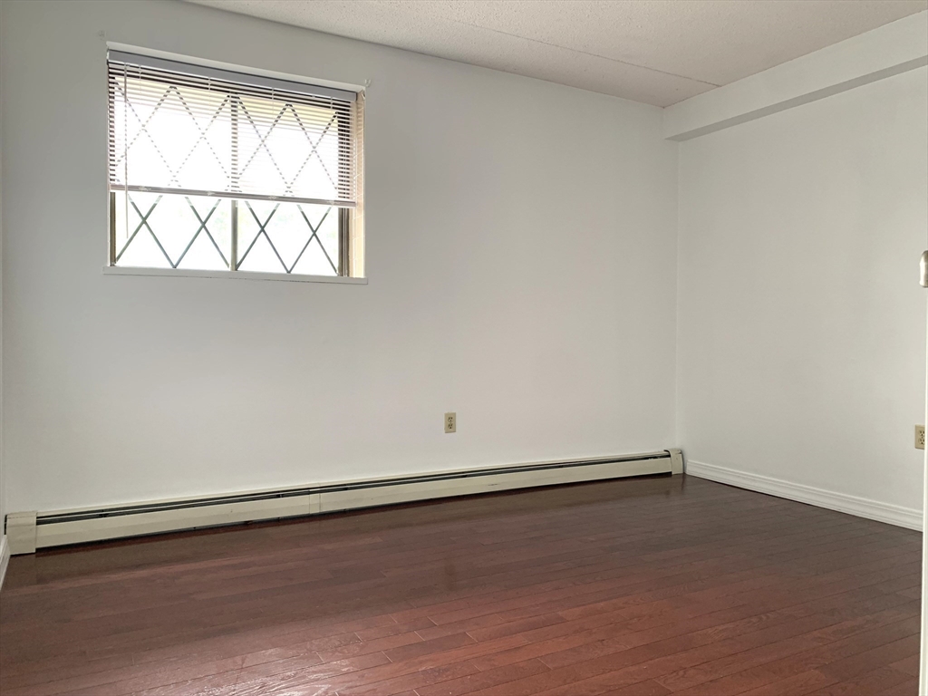 301 Lowell Street, Unit 34 Somerville, MA 02145 - Photo 10 of 15 an empty room with a window
