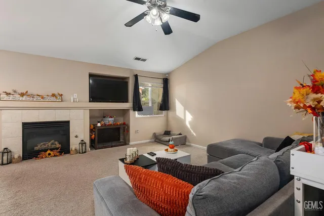 a living room with furniture a fireplace and a flat screen tv
