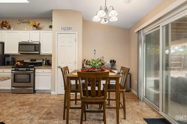 a view of a dining room with furniture wooden floor and a chandelier