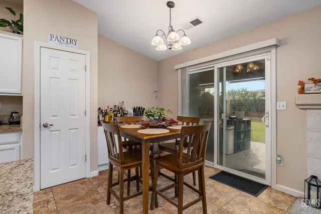 a view of a dining room with furniture and window