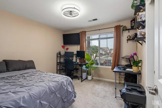 a bedroom with a bed and a desk