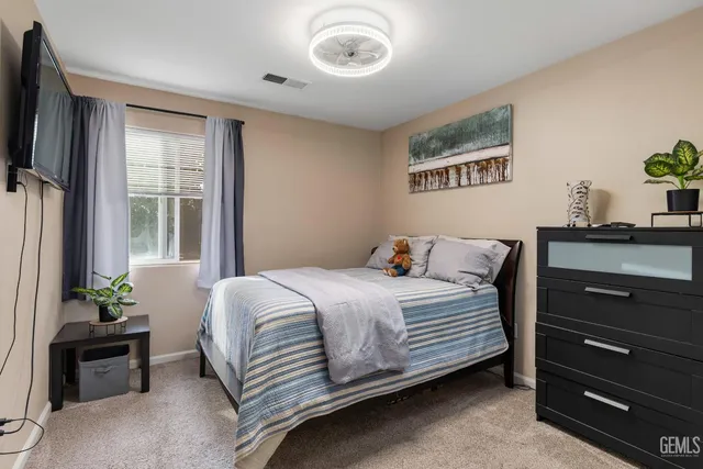 a bedroom with a bed and a dresser