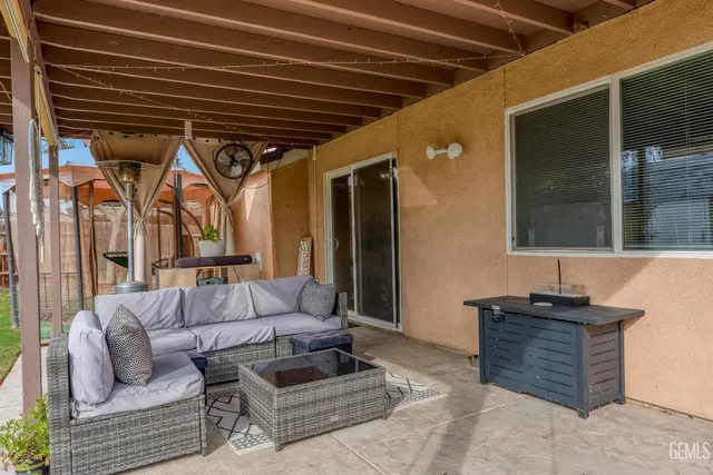a bedroom with furniture and a large window