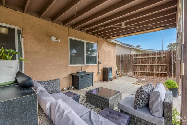 a backyard of a house with table and chairs