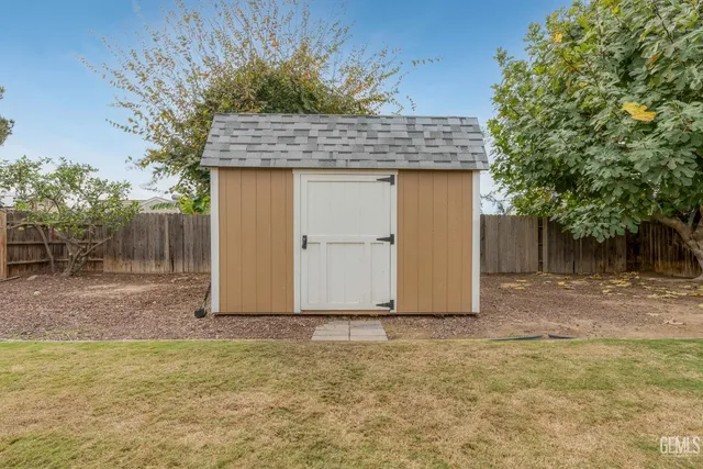 a view of a house with backyard and a tree