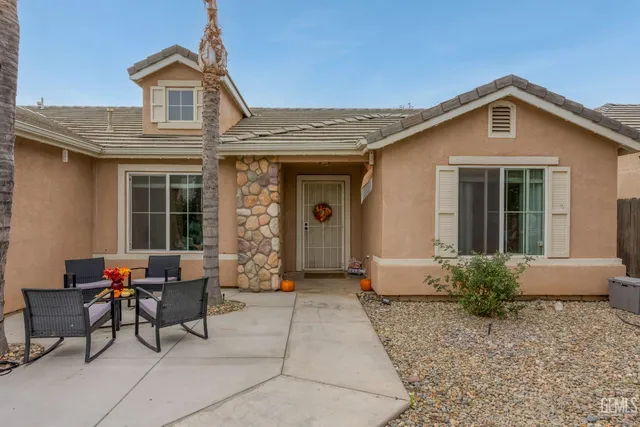 a front view of a house with outdoor seating