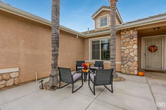 a balcony with table and chairs