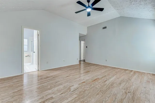 a view of a room with wooden floor and white walls