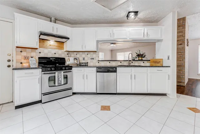 a kitchen with cabinets a stove a sink and a oven