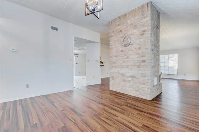 a kitchen with granite countertop a sink stainless steel appliances and cabinets