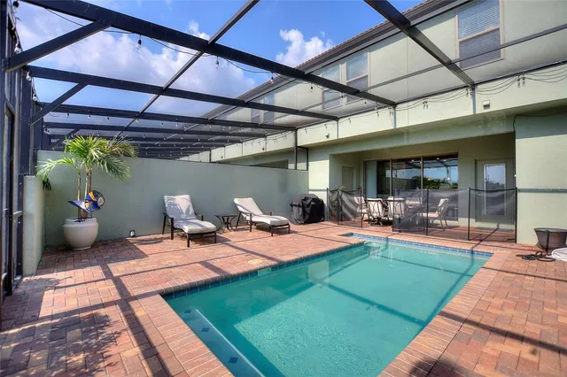 a view of a backyard with table and chairs under an umbrella